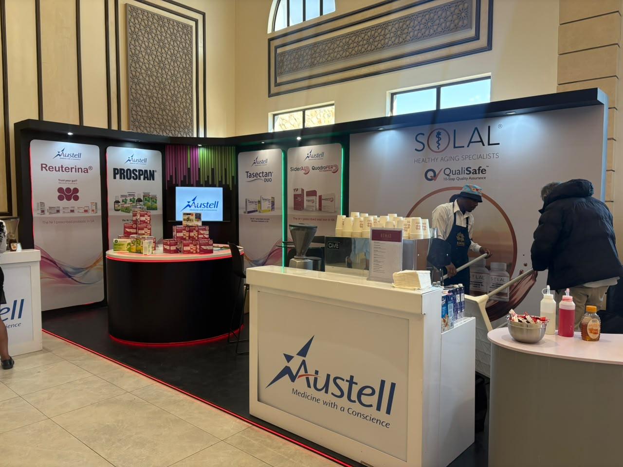 Custom exhibition stand built for Austell, showing the coffee service counter alongside the product display