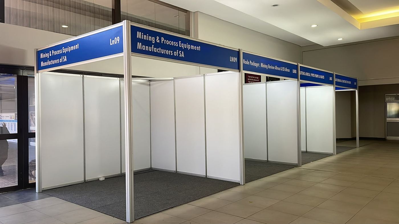 Shell scheme exhibition stands built for Mining & Process Equipment Manufacturers of SA, with branded fascia signage in a row of modular stands